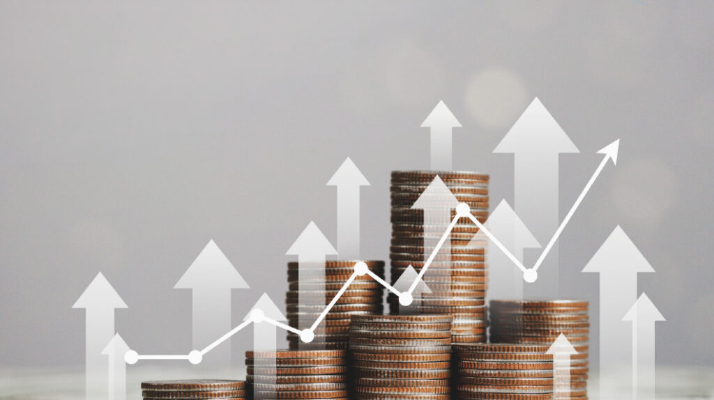 A graphic of stacked coins with a line graph overlay showing growth.
