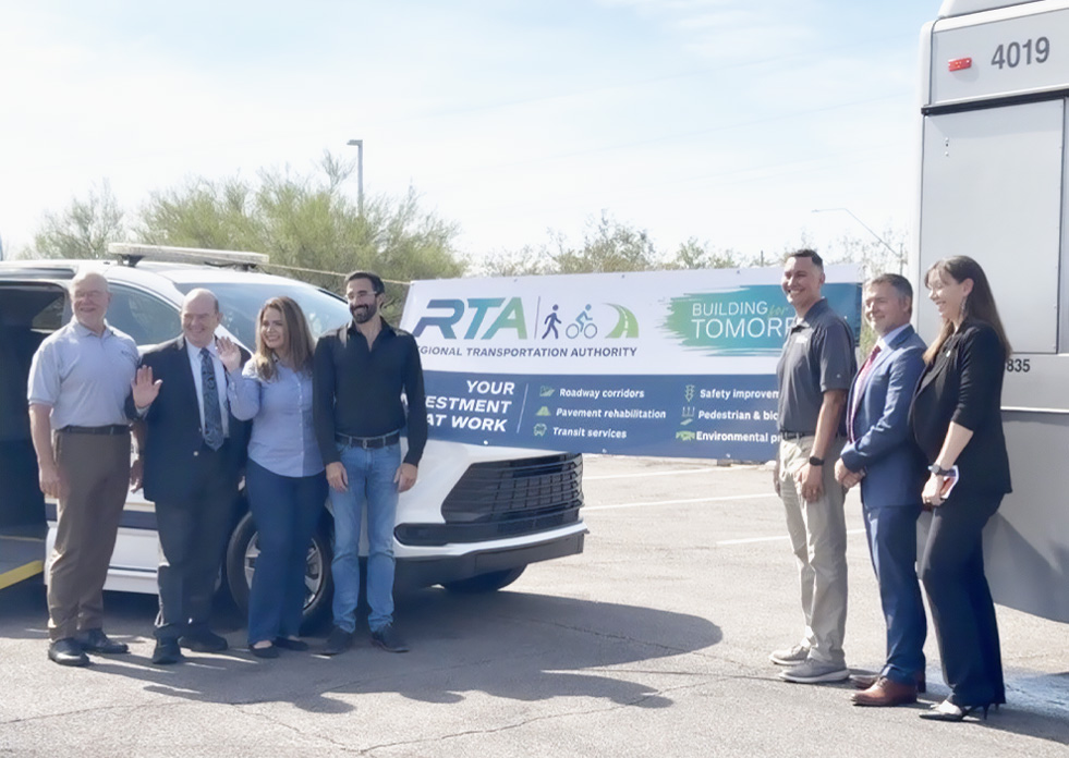 Members of the RTA Board pose in front of an RTA banner.
