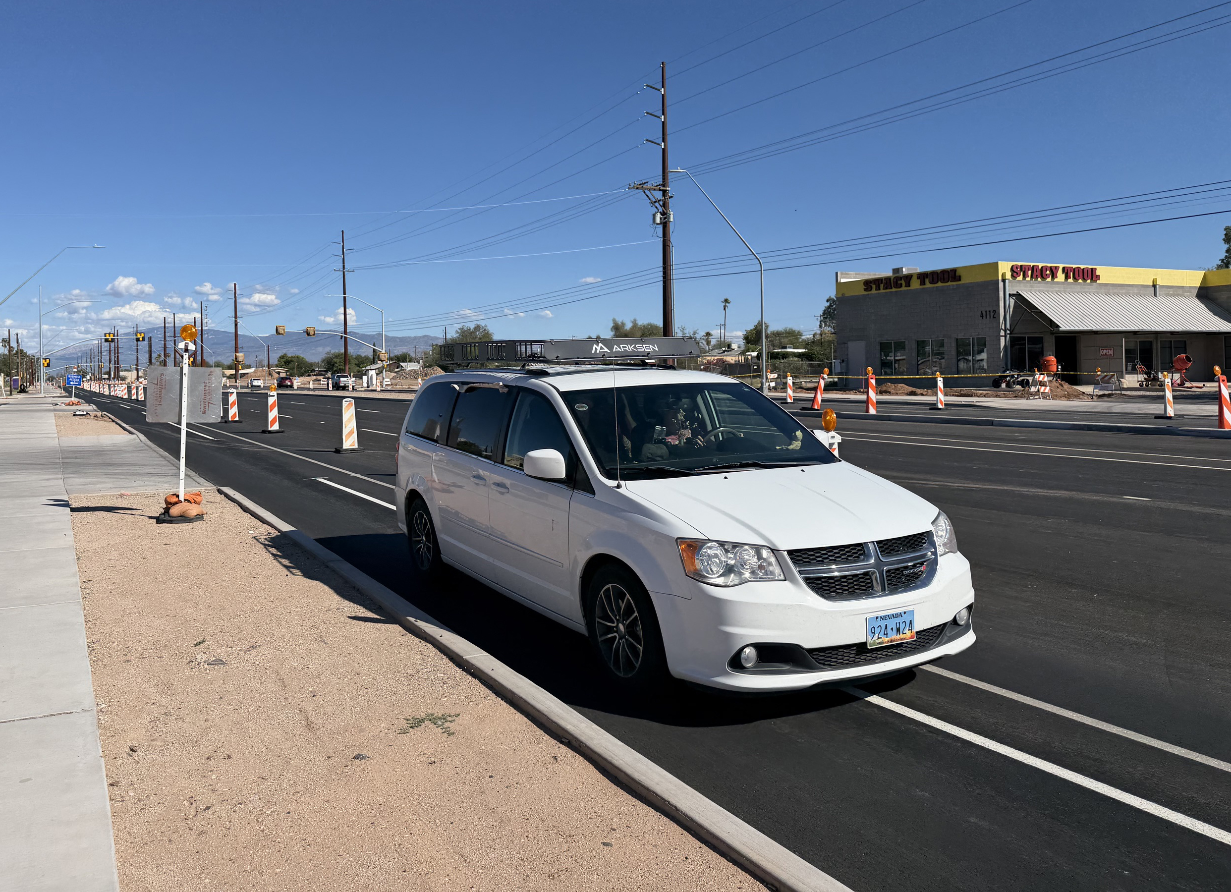 A vehicle drives through the construction on Grant Road.