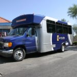 A Sun Shuttle van at a stop.
