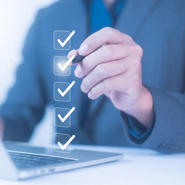 A person points to a floating checkmark with his pen (digital image).